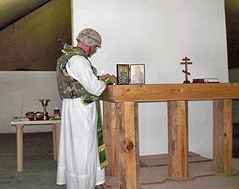 Fr. Jerome prepares in the Proskomedia under fire